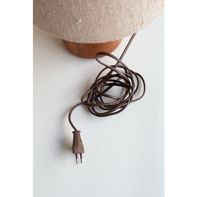 A pair of teak table lamps produced by Kirk in Denmark during the 1960s. Defined by their compact proportions and...