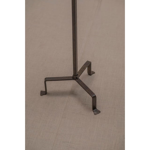 Elegant French floor-standing torch from the 1960s, crafted from metal with a beautifully aged, dark patinated finish. The...