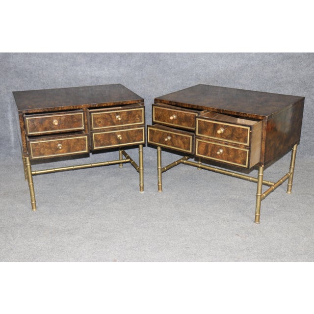 Dimensions: 24 inches high x 28 inches wide x 21.25 inches deep A striking pair of Regency style burl wood and brass...