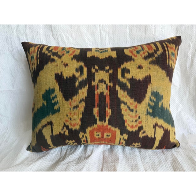 Exceptional antique ikat pillow created from a handwoven 19th century Central Asian textile fragment. The composition...