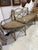 A distinctive antique French iron bench composed of three individual sections that connect together to form one long...