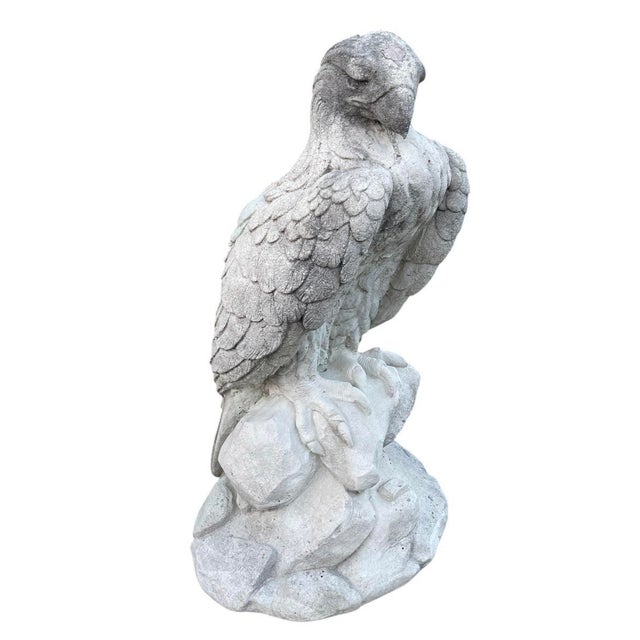 This impressive vintage garden statue depicts a majestic eagle perched atop a rocky crag. Crafted from durable cast stone...
