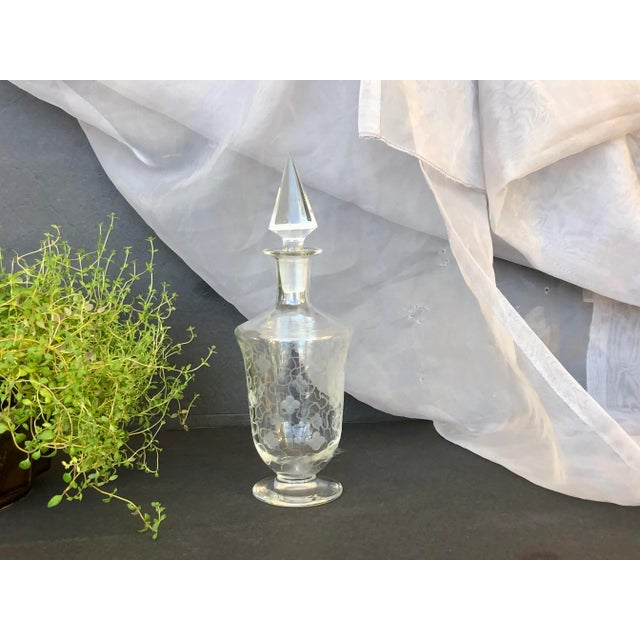 Display this antique wheel-etched glass perfume vanity bottle on a bathroom shelf or bedroom dresser as a unique decor...