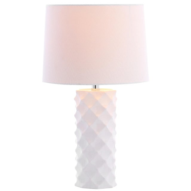 Update any living room with the chic, sophisticated style of this contemporary table lamp. Crafted to highlight it's bold...