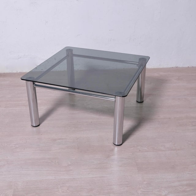 Beautiful coffee table in metal and smoked glass Italy, 1970s. Removable glass. Dimensions: Glass 72 x 72 cm Height 39 cm...