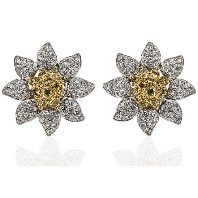 18k Earrings with 1.49 carats of natural yellow color round diamonds and 1.95 carats of white round brilliant diamonds....