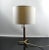 Decorative mid century table lamp with a tripod base made of teak and brass. I have official proof of authenticity such as...