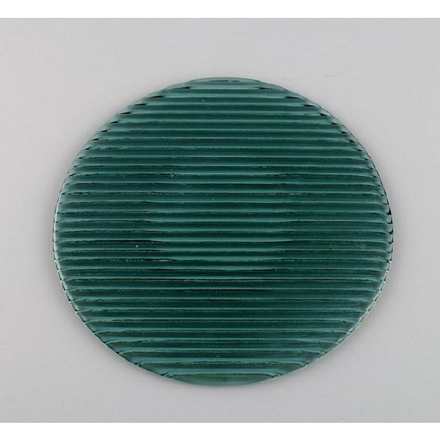 Per Lütken for Holmegaard. Twelve "Buffet" plates in blue-green mouth-blown art glass. 1980s. Diameter: 17.5 - 19 cm. In...
