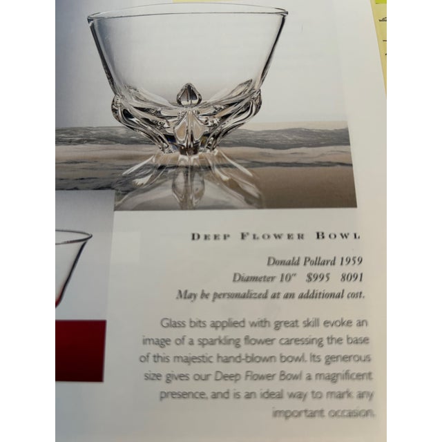 Designed by Donald Pollard in 1959, This deep but fine-walled bowl appears to be supported by a sparkling flower of glass...