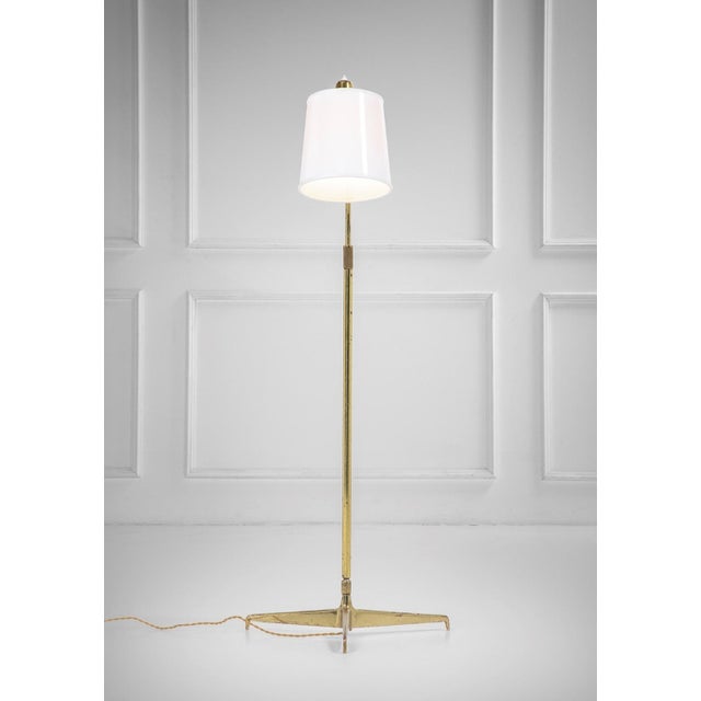 Model 301 Floor Lamp in Beige Cone-Shaped Tripod Base by Angelo Ostuni for Oluce, 1950s, in Very Good conditions. Designed...