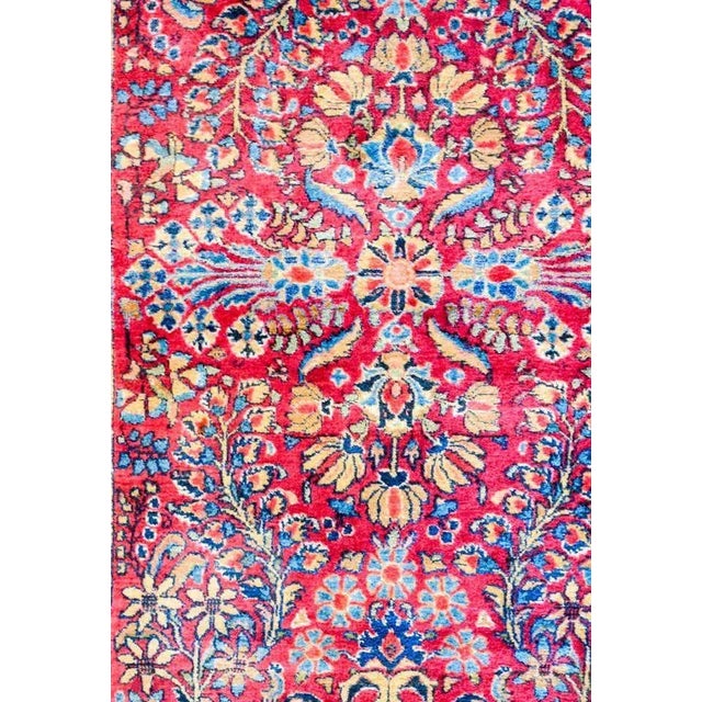 A beautiful early 20th century Persian Sarouk rug with a fantastic mirrored floral and vine pattern, expertly rendered, in...