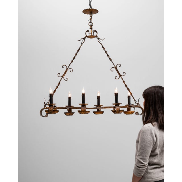 This 20th Century French Gothic Revival metal torch chandelier embodies the dramatic, handcrafted character associated...
