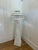 Vintage floor lamp with woven wicker construction in white finish. Features a tall tapered base and tiered dome shade with...