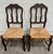 This is a charming pair of antique French Provincial side chairs featuring beautifully carved crest rails with shell and...