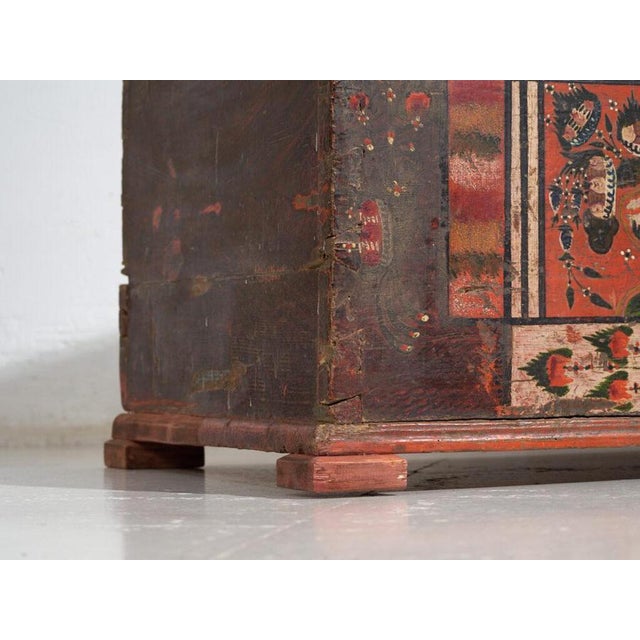 Tyrolean polychrome pine trunk with geometric panels in cream, red and black on a dark ground, dated 1906. A folk piece...