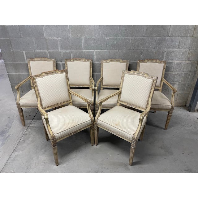 Timeless and elegant set of 6 French Louis XVI bergere style arm chairs upholstered in a neutral textured plaid that...