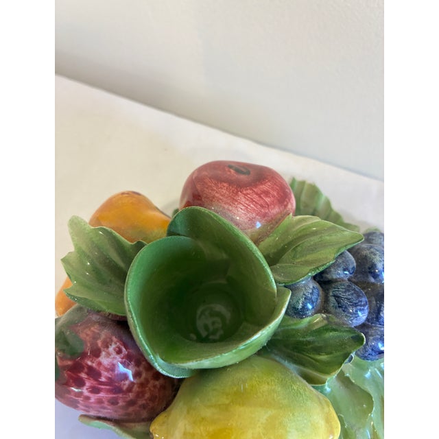 A beautifully crafted vintage Italian Capodimonte porcelain taper candle holder featuring an elegant arrangement of hand-...