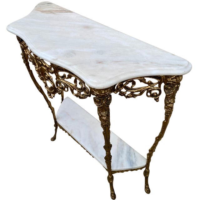 A Louis XV Rococo style console and mirror set in gilt brass with a white marble top. Very good condition. Mirror...