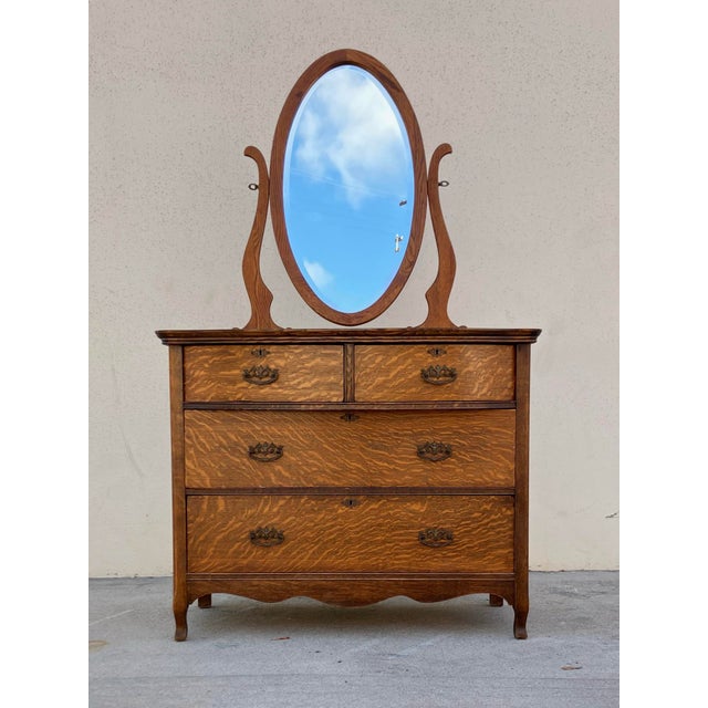 ** original mirror replaced with second photo. This tiger oak dresser with mirror is an antique from the late 19th/early...
