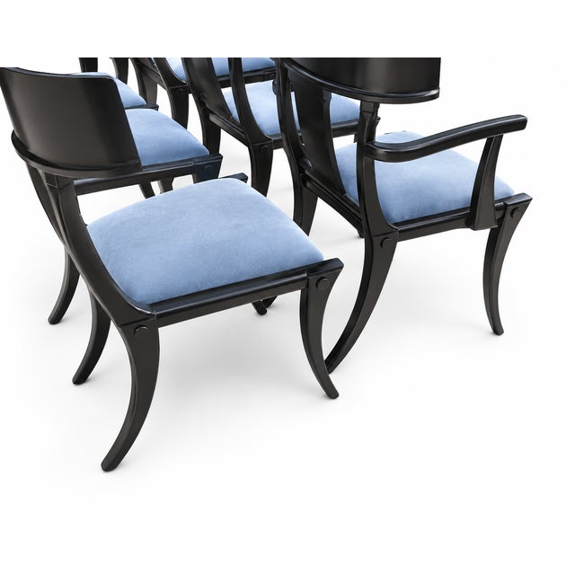 Modern set of Klismos style dining chairs. The set consists of 6 armless and 2 captains chairs. The chairs are well made...