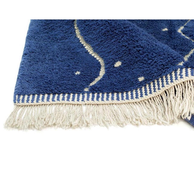 Vibrant hand-knotted rug featuring a combination of deep Navy Blue and Ivory colors, adorned with captivating abstract...