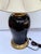 A striking signed Frederick Cooper table lamp featuring a glossy black marbleized body with warm gold veining, paired with...