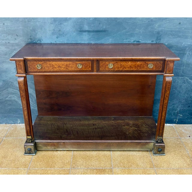 Elegant Empire Revival console table crafted in wood with richly figured burl veneer accents, dating to the mid 20th...