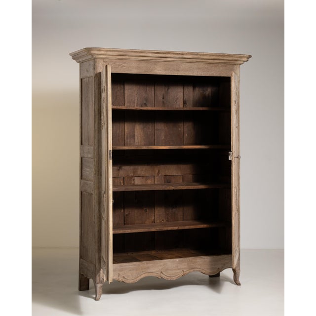 A refined example of Louis XV influence carried gracefully into the early nineteenth century, this French oak wardrobe...