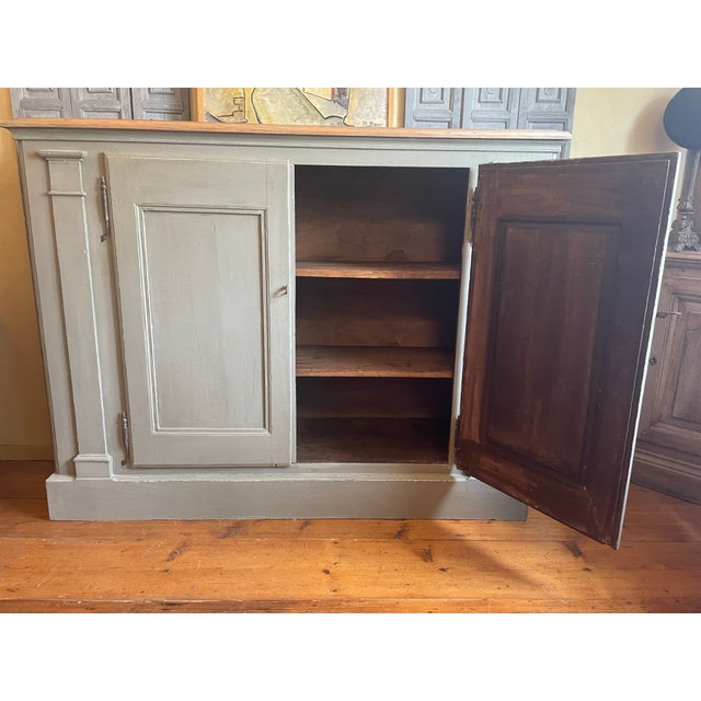 A magnificent wide cabinet with beautiful columns, an imposing iron clasp, and amazing forged hinges. The cabinet dates...