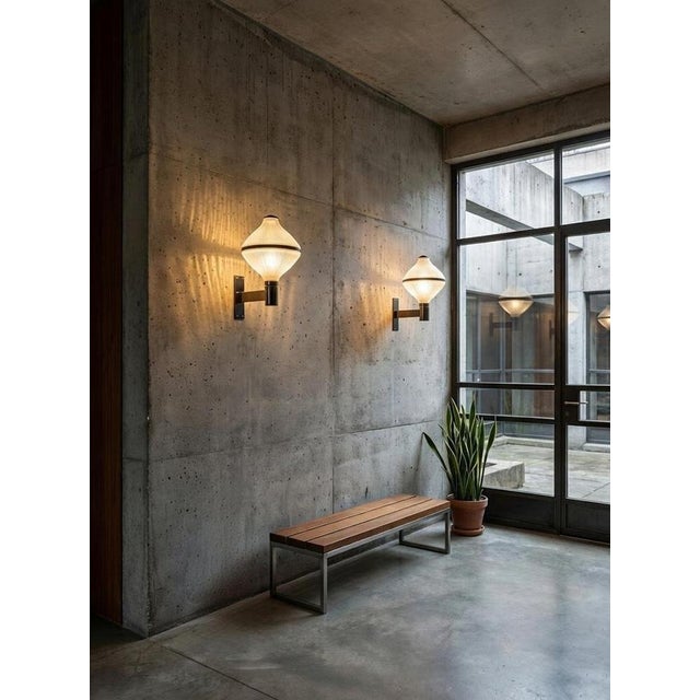 His pair of polimnia wall lamps, designed by bbpr (banfi, belgiojoso, peressutti, rogers) in the 1950s, represents a...