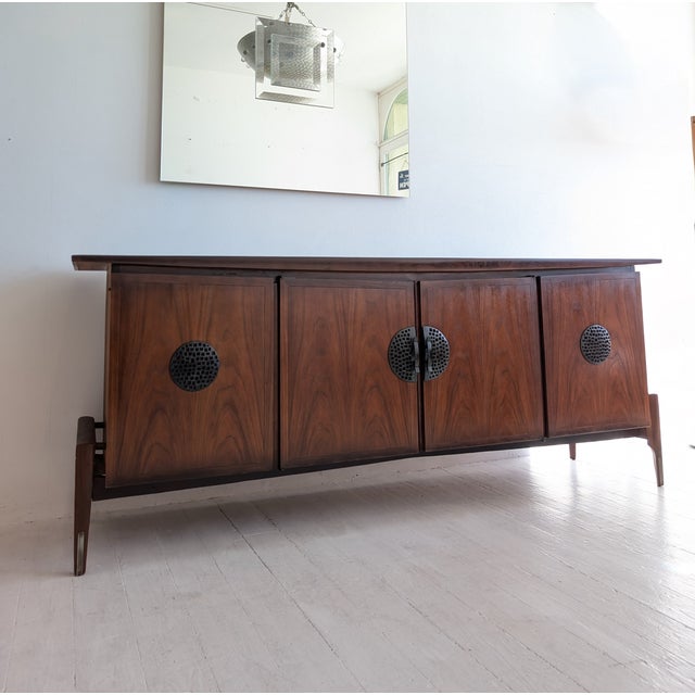 Rare sculptural mid century walnut sideboard by Helen Hobey Baker, USA 1960s. Brutalist metal medallions on the doors....