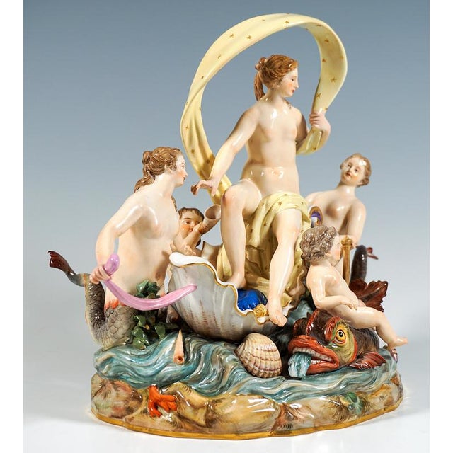 Excellent meissen porcelain group of the 19th century: nymph, covered only with a cloth, seated on a half shell floating...