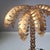 This palm tree lamp features a square base in a gold-coloured metal frame with black glass plates on all sides and a metal...