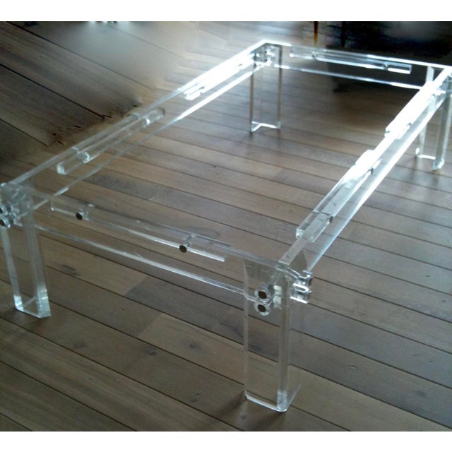 This 1970's Vintage Chunky Lucite Coffee Table, in the style of Charles Hollis Jones. with a glass top is a unique and...