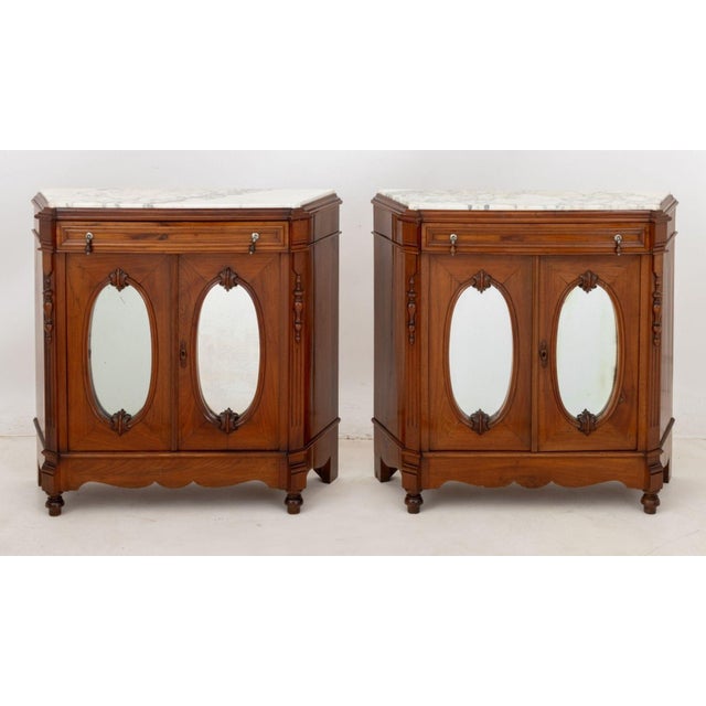 Pair of Victorian Marble Top Walnut Sideboards, 20th century, each with Carrara marble top above frieze drawer and two...