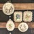 A pristine collection of eight German hand-painted wax relief wall plaques (Wachsbilder). Meticulously crafted in Bavaria...