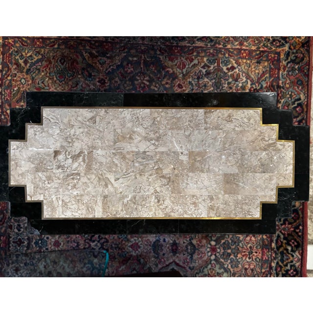 Post modern tessellated stone table with ziggurat shaped sides, polished stone, and brass inlay. Not shipped with glass,...