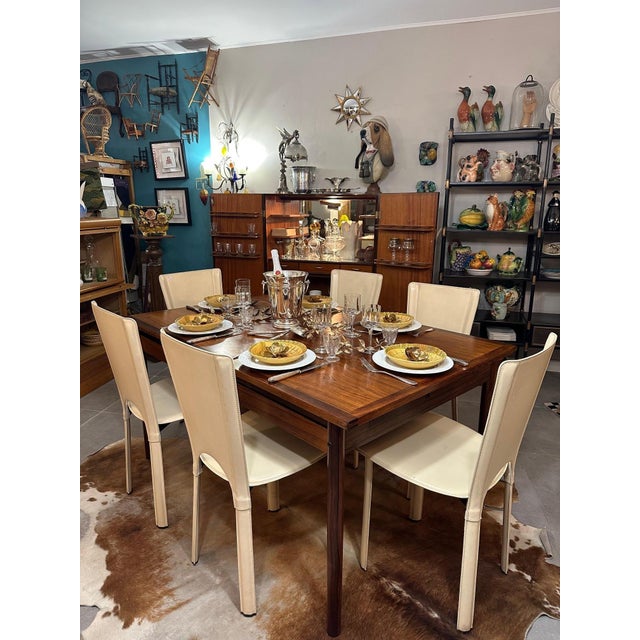 Stunning 1950s Danish dining table in solid rosewood, a precious wood prized for its deep grain and warm hue. The tabletop...