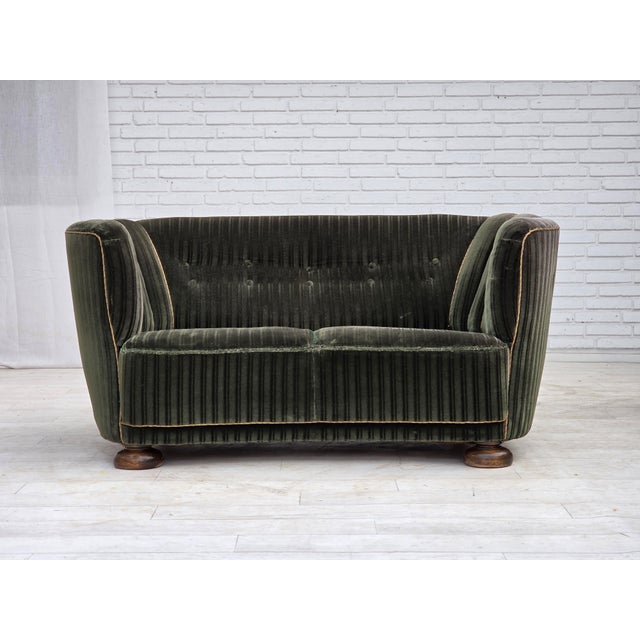 1960s, Danish 2-seater curved sofa. Green striped furniture velour, oak wood legs, brass springs in the seat. Original...