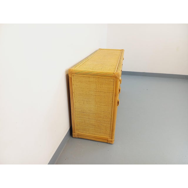 Vintage 1970s sideboard in rattan and woven rattan, offering ample storage: 4 doors with 1 large interior shelf, 3...
