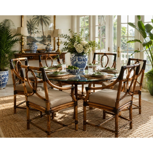 A handsome set of six authentic McGuire dining armchairs, showcasing the California maker’s iconic blend of organic...