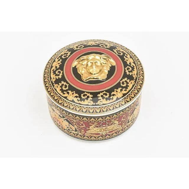 This wonderful Rosenthal Versace Medusa porcelain box is 2 parts. It is very Versace embellished design with great rich...