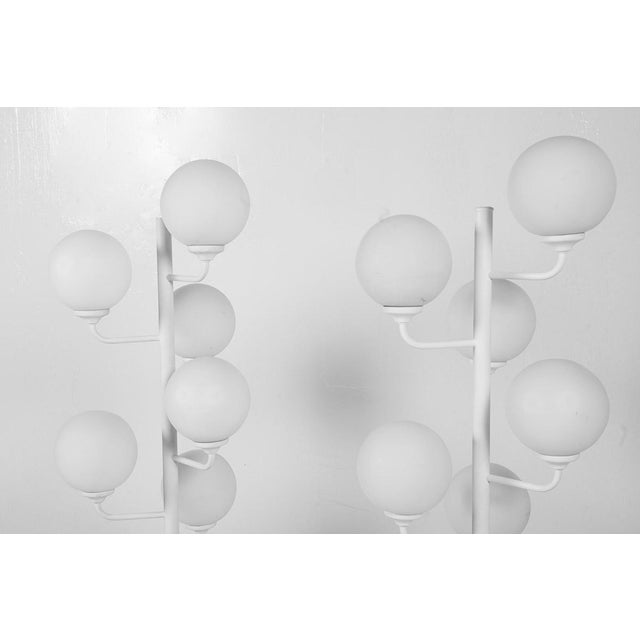 Space-age 1960s floor lamp, featuring 9 milk glass spheres protruding like branches from a metal base lacquered white. In...