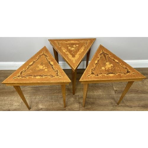 A beautifully elegant set of Vintage French nested tables, featuring striking triangular tops adorned with intricate...