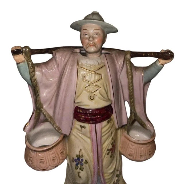 A delightful example of Early 20th-century Chinoiserie craftsmanship, this vintage porcelain nodder figurine features a...
