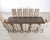 A monumental dining suite comprised of a massive walnut dining table and twelve opulent dining chairs made by Ferrell and...
