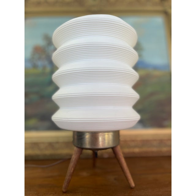 In style of Angelo Lelli, mid-century sculptural table lamp possibly from the 1950s, featuring a wooden tripod body,...
