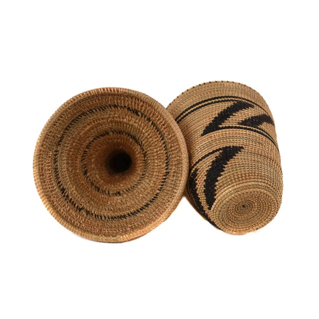 The Tutsi Tight Weave Basket with Lid from Rwanda epitomizes the artistry and tradition of the Tutsi community's weaving...