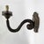 A pair of 18th-century embossed copper arms, mounted on a carved poplar wood core and silvered along the base edge. In...