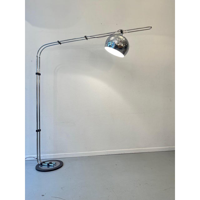 A curved, arc-shaped floor lamp produced by Zonca Illuminazione in Italy around 1970. It features a circular cast iron...